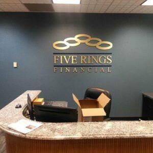 five rings financial gold logo office lobby sign
