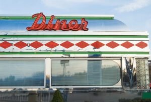 Diner with sign in bright red neon in a retro style restaurant