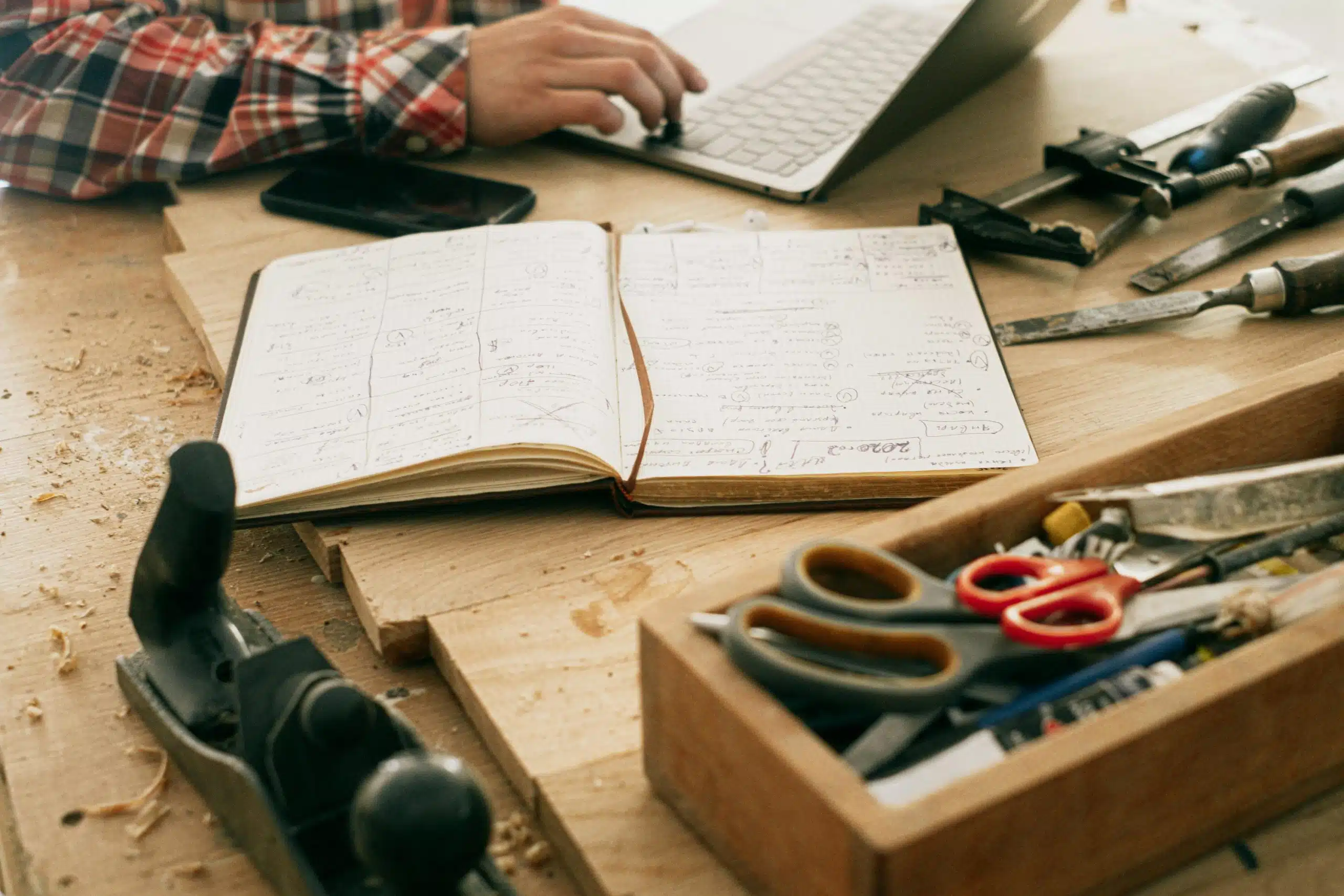 A notebook on a table with tools